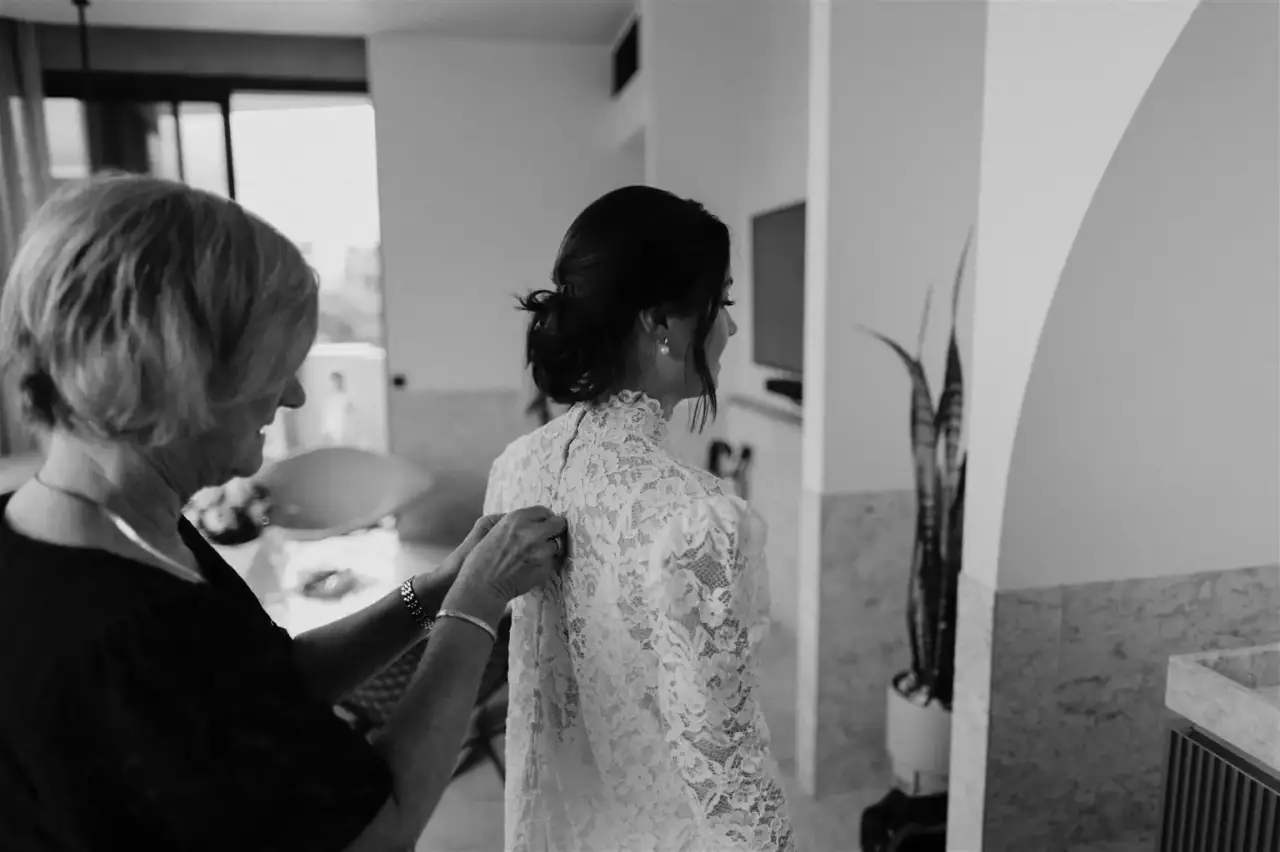 Christian adjusts his velvet Hugo Boss suit in The Calile Hotel's minimalist interior, showcasing the venue's signature pastel aesthetic
